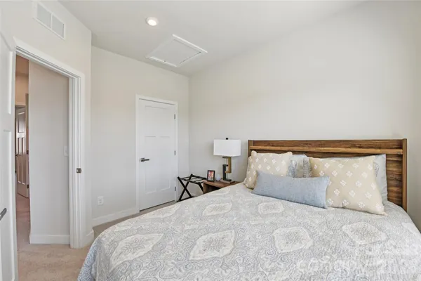 a bedroom with a bed and a night stand