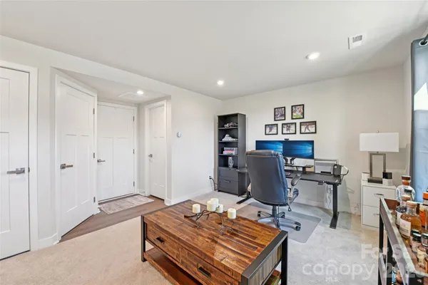a bedroom with furniture and a rug