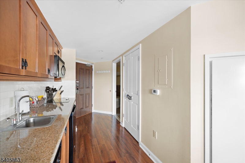 200 Highway 94, Unit 249 Vernon, NJ 07462 - Photo 11 of 28 a kitchen with granite countertop wooden cabinets a sink and dishwasher
