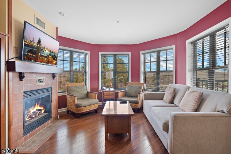 200 Highway 94, Unit 249 Vernon, NJ 07462 - Photo 16 of 28 a living room with furniture a fireplace and a large window