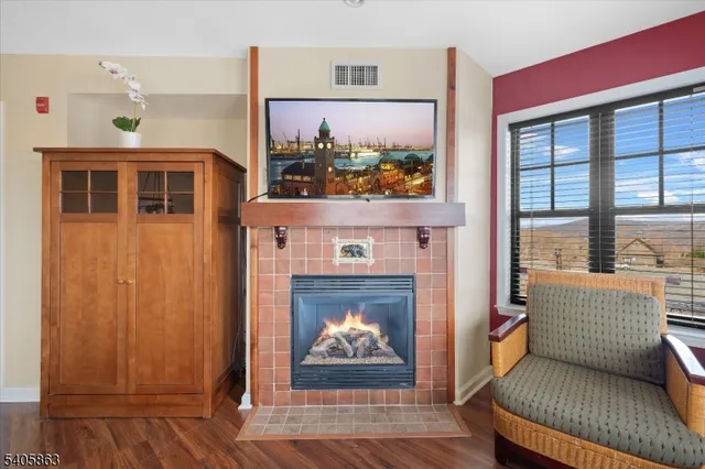 a living room with furniture a fireplace and a flat screen tv