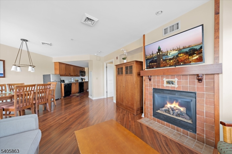 200 Highway 94, Unit 249 Vernon, NJ 07462 - Photo 19 of 28 a living room with furniture a fireplace and a flat screen tv
