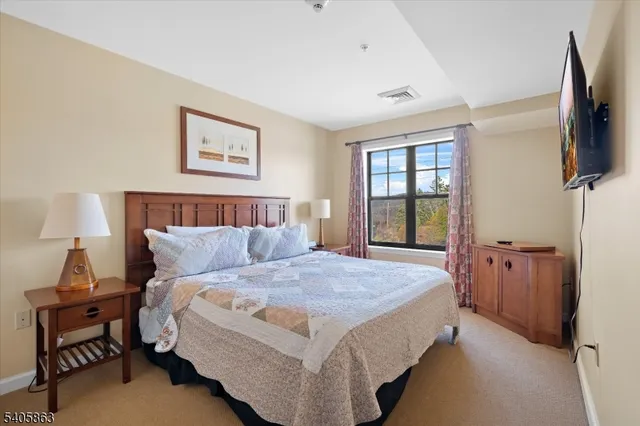 a bedroom with a bed and a couch