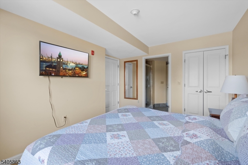 200 Highway 94, Unit 249 Vernon, NJ 07462 - Photo 23 of 28 a view of a bedroom with a large bed and a painting on the wall