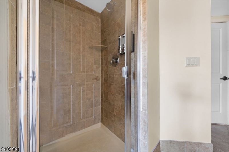 200 Highway 94, Unit 249 Vernon, NJ 07462 - Photo 24 of 28 a bathroom with a glass shower door