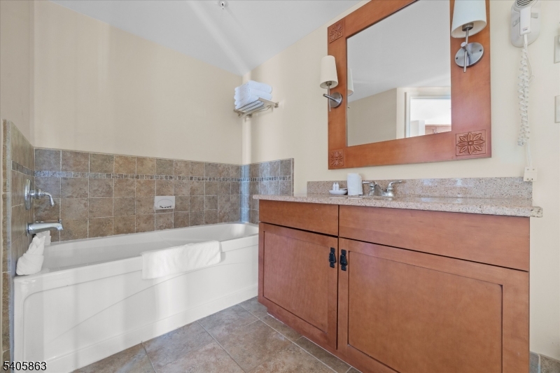 200 Highway 94, Unit 249 Vernon, NJ 07462 - Photo 25 of 28 a bathroom with a bathtub and a sink