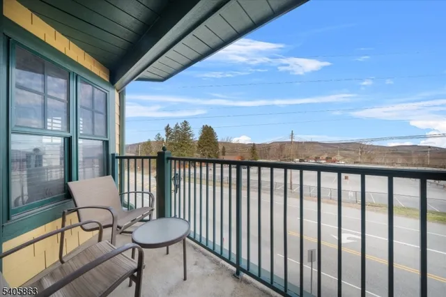 a balcony with table and chairs