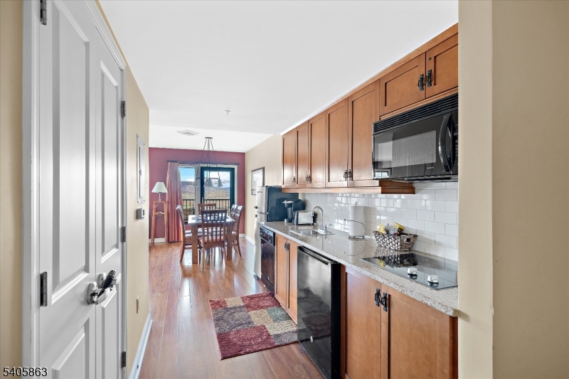 200 Highway 94, Unit 249 Vernon, NJ 07462 - Photo 6 of 28 a kitchen with stainless steel appliances granite countertop a stove a sink and a microwave