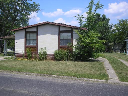 2464 East 29th Road, Unit 60 Seneca, IL 61360 - Photo 1 of 1 a house that has a tree in front of it