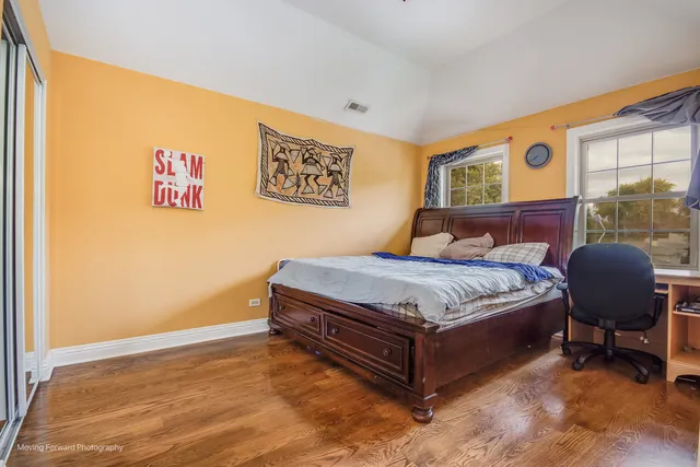 a bedroom with a bed and chair