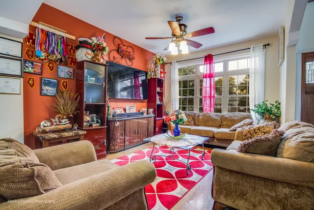 a living room with furniture kitchen and a chandelier