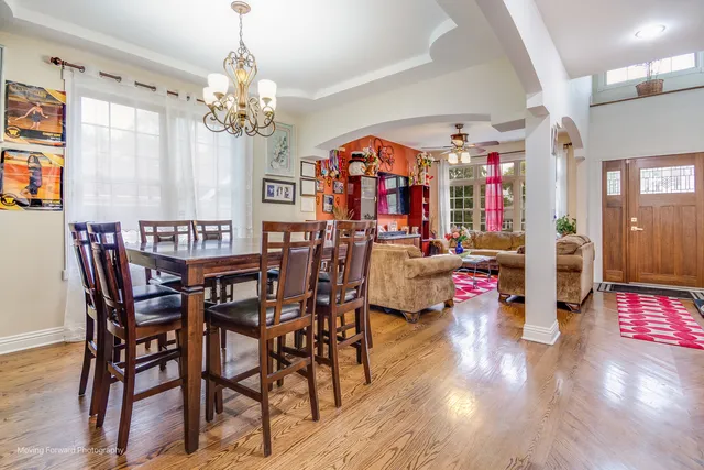 a view of a dining room with furniture and chandelier