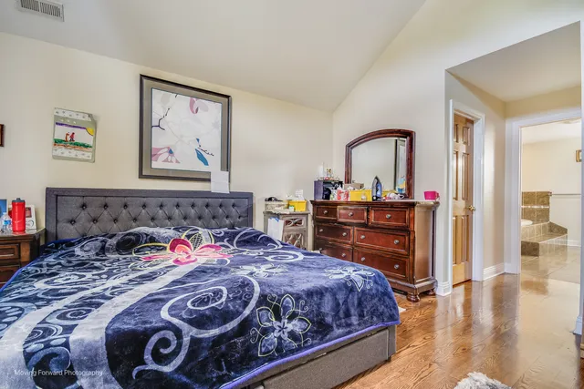 a bedroom with a bed and a dresser