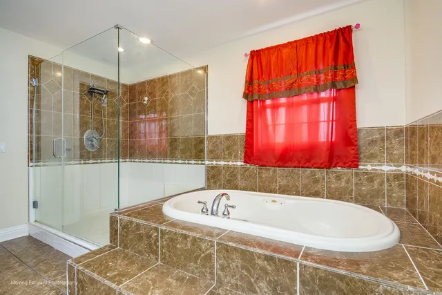 a bathroom with a bathtub and shower