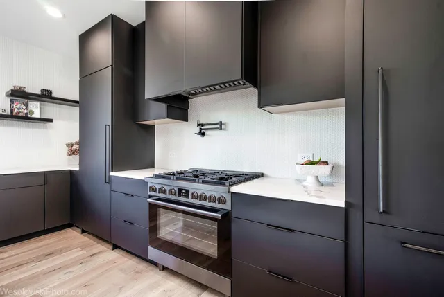 a kitchen with stainless steel appliances granite countertop a stove and a microwave