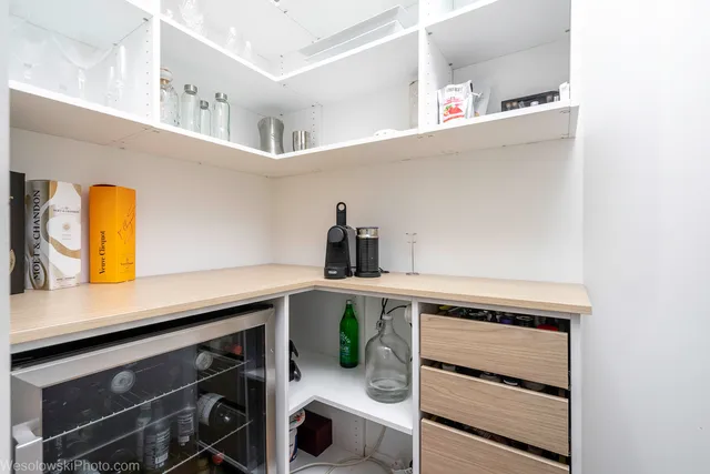 a kitchen with a refrigerator and a sink