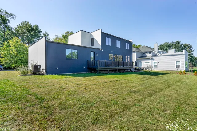 an aerial view of a house with a yard swimming pool and outdoor seating