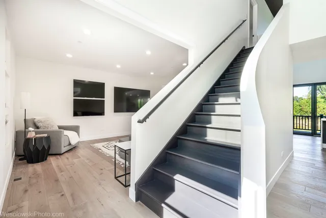 a view of entryway and hall with wooden floor