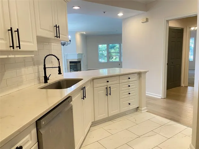 en empty room with a fireplace and cabinet