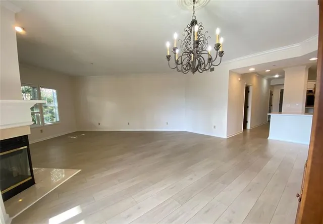 a view of a livingroom with a chandelier closet and windows