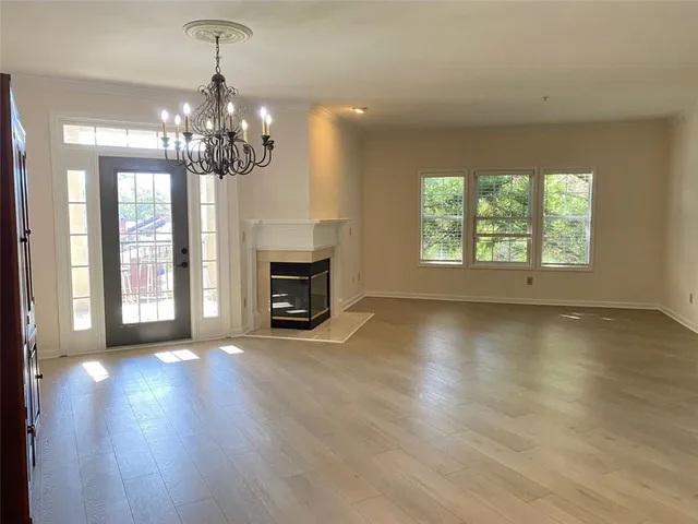 a view of a hallway with a chandelier fan
