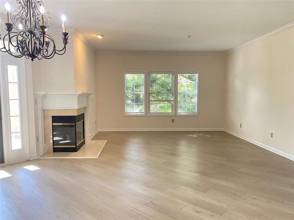 3047 Lenox Road Northeast, Unit 1202 Atlanta, GA 30324 - Photo 22 of 69 an empty room with windows and fireplace