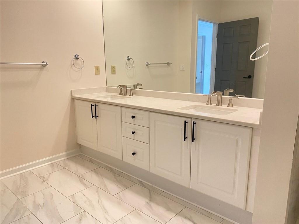 3047 Lenox Road Northeast, Unit 1202 Atlanta, GA 30324 - Photo 35 of 69 a bathroom with a sink and a mirror