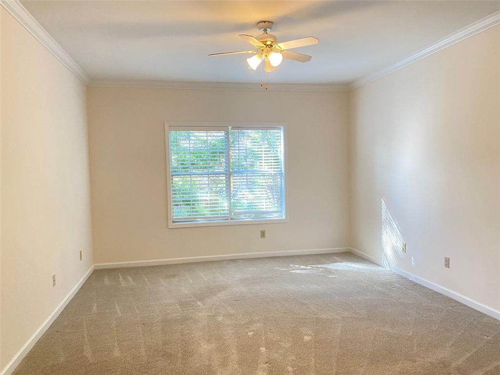 3047 Lenox Road Northeast, Unit 1202 Atlanta, GA 30324 - Photo 37 of 69 an empty room with a window and a fan