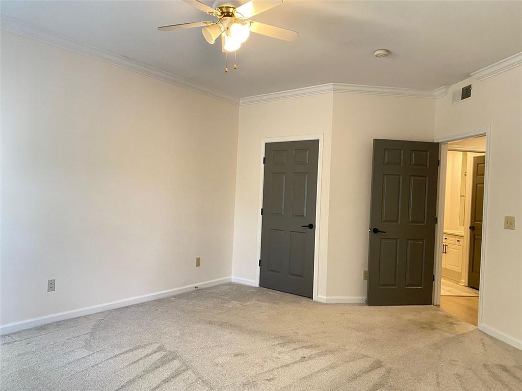 3047 Lenox Road Northeast, Unit 1202 Atlanta, GA 30324 - Photo 38 of 69 an empty room with closet and a chandelier fan