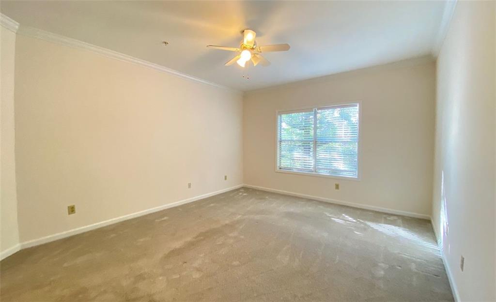 3047 Lenox Road Northeast, Unit 1202 Atlanta, GA 30324 - Photo 39 of 69 an empty room with a window and a ceiling fan