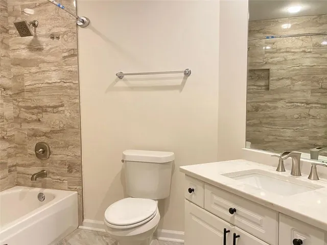 an aerial view of a house with a yard and a large trees