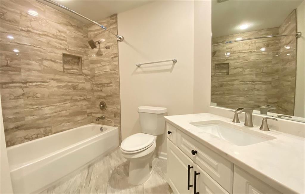 3047 Lenox Road Northeast, Unit 1202 Atlanta, GA 30324 - Photo 42 of 69 a bathroom with a sink a toilet and shower