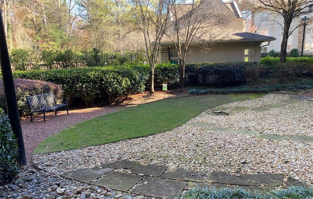 3047 Lenox Road Northeast, Unit 1202 Atlanta, GA 30324 - Photo 49 of 69 a front view of a house with a garden