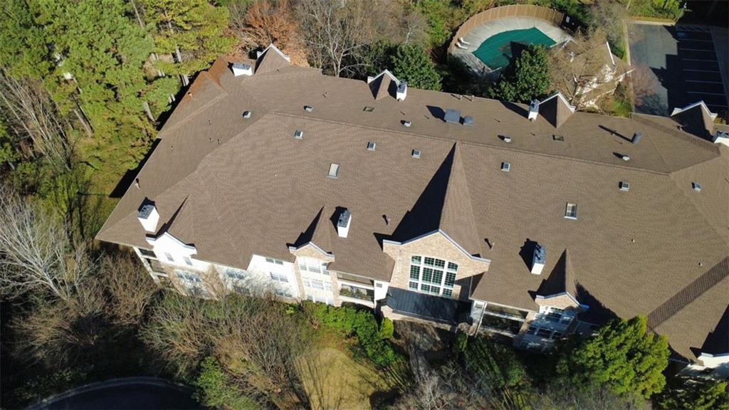 3047 Lenox Road Northeast, Unit 1202 Atlanta, GA 30324 - Photo 56 of 69 an aerial view of a house with a yard and trees