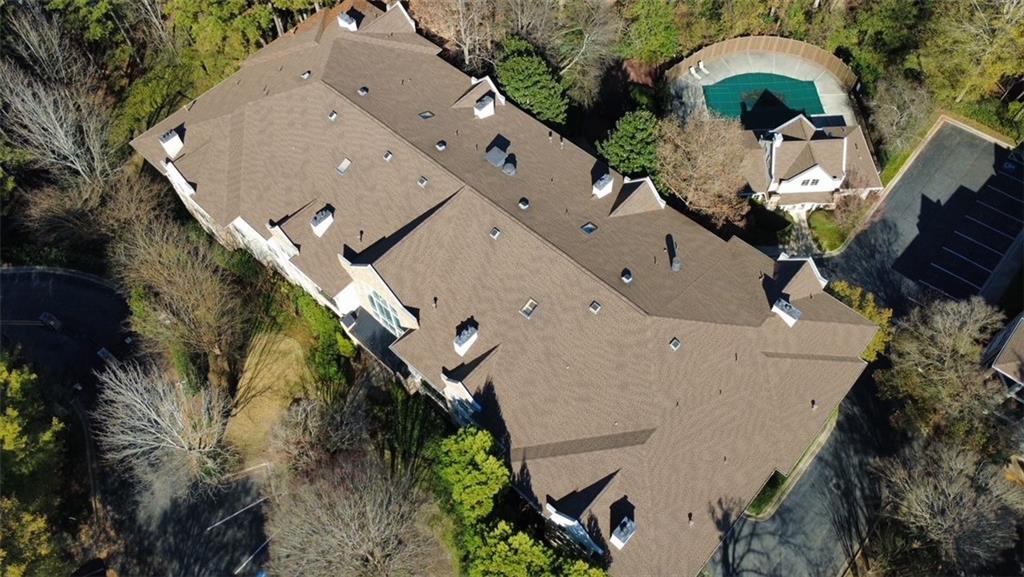3047 Lenox Road Northeast, Unit 1202 Atlanta, GA 30324 - Photo 58 of 69 an aerial view of a house with a yard and a large trees