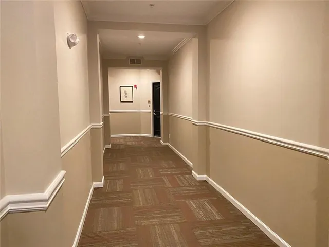 a kitchen with stainless steel appliances a sink cabinets and wooden floor