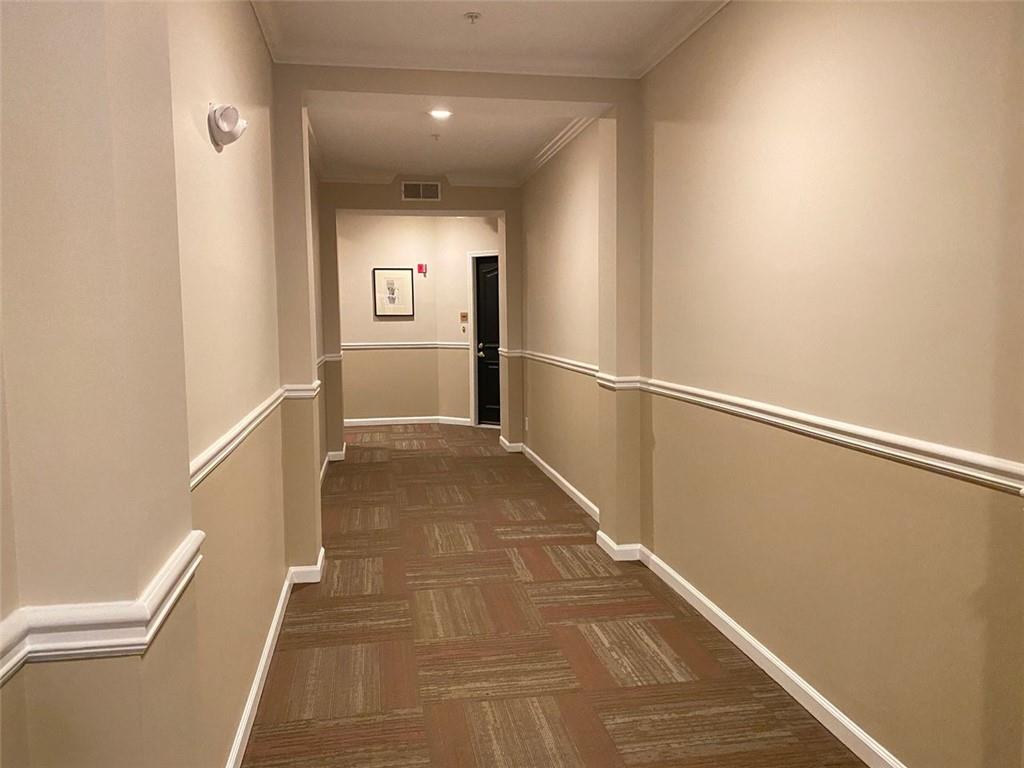 3047 Lenox Road Northeast, Unit 1202 Atlanta, GA 30324 - Photo 9 of 69 a view of a hallway with wooden floor and staircase