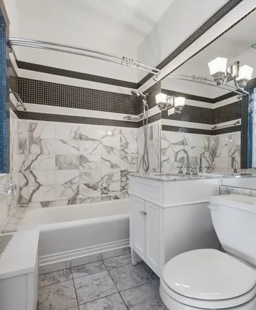 a bathroom with a toilet and a bathtub