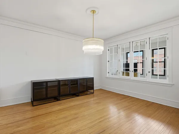 a view of a room with wooden floor and cabinet