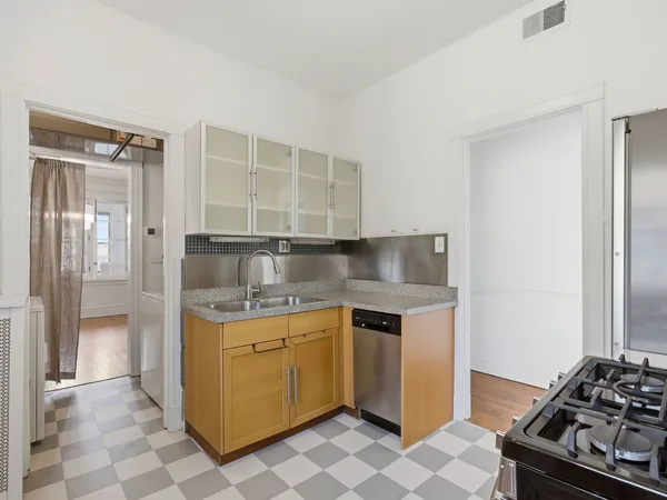 a kitchen with stainless steel appliances granite countertop a stove and a refrigerator