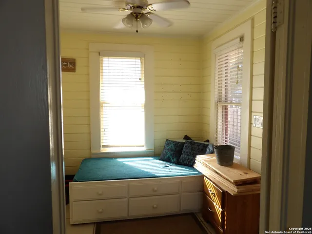 a bedroom with a bed and a window