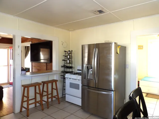 a kitchen with stainless steel appliances a refrigerator and a stove top oven