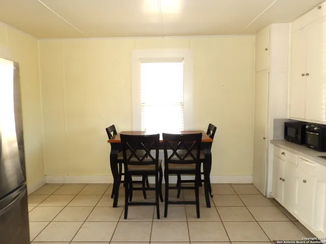 a view of a dining room with furniture and a window