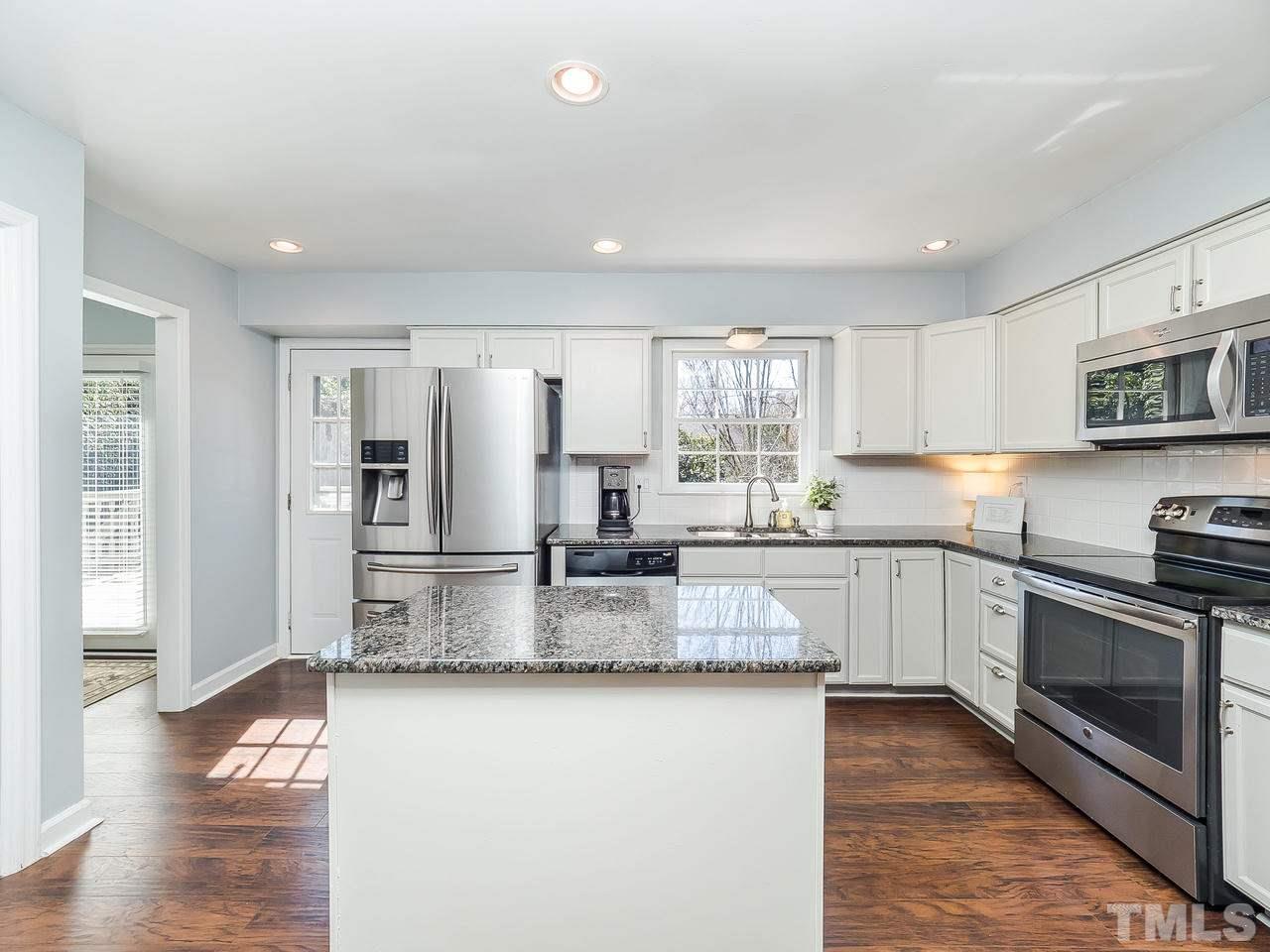 2002 Port Royal Road Raleigh, NC 27609 - Photo 2 of 23 a kitchen with stainless steel appliances granite countertop a refrigerator a stove a sink and a microwave