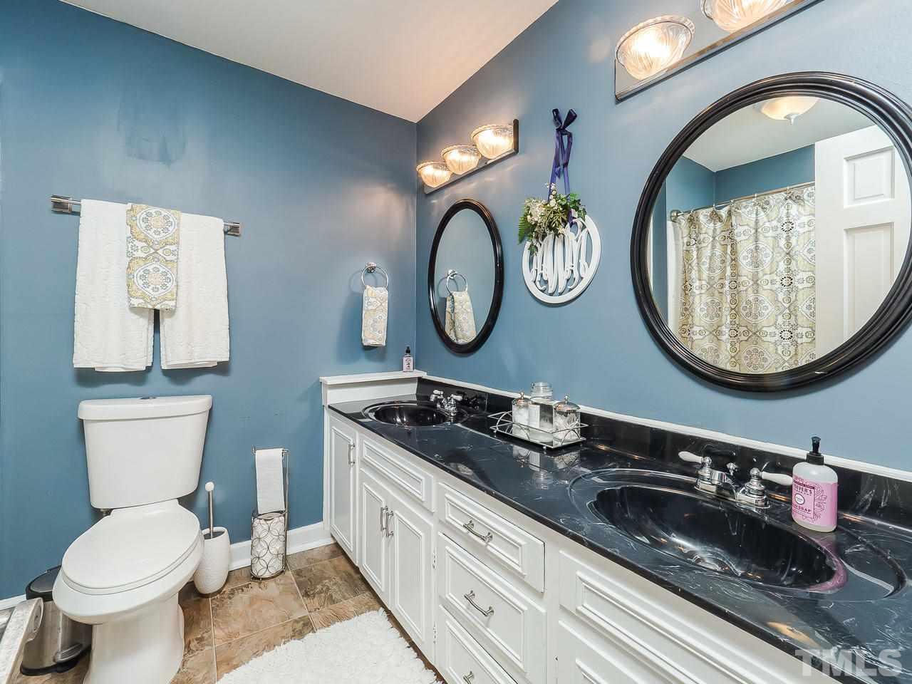 2002 Port Royal Road Raleigh, NC 27609 - Photo 12 of 23 a bathroom with a toilet a sink and a mirror