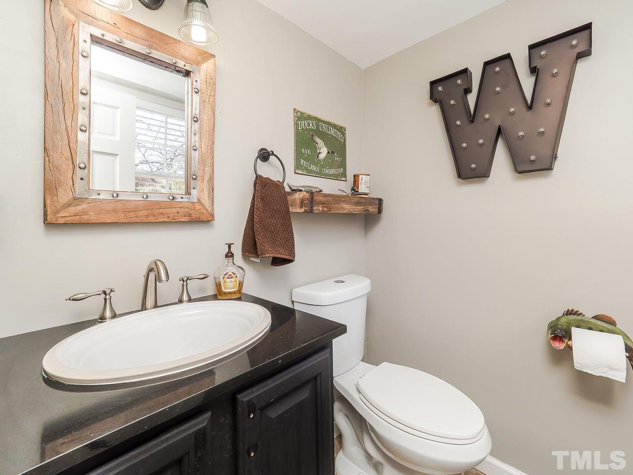 2002 Port Royal Road Raleigh, NC 27609 - Photo 17 of 23 a bathroom with a toilet a sink and mirror