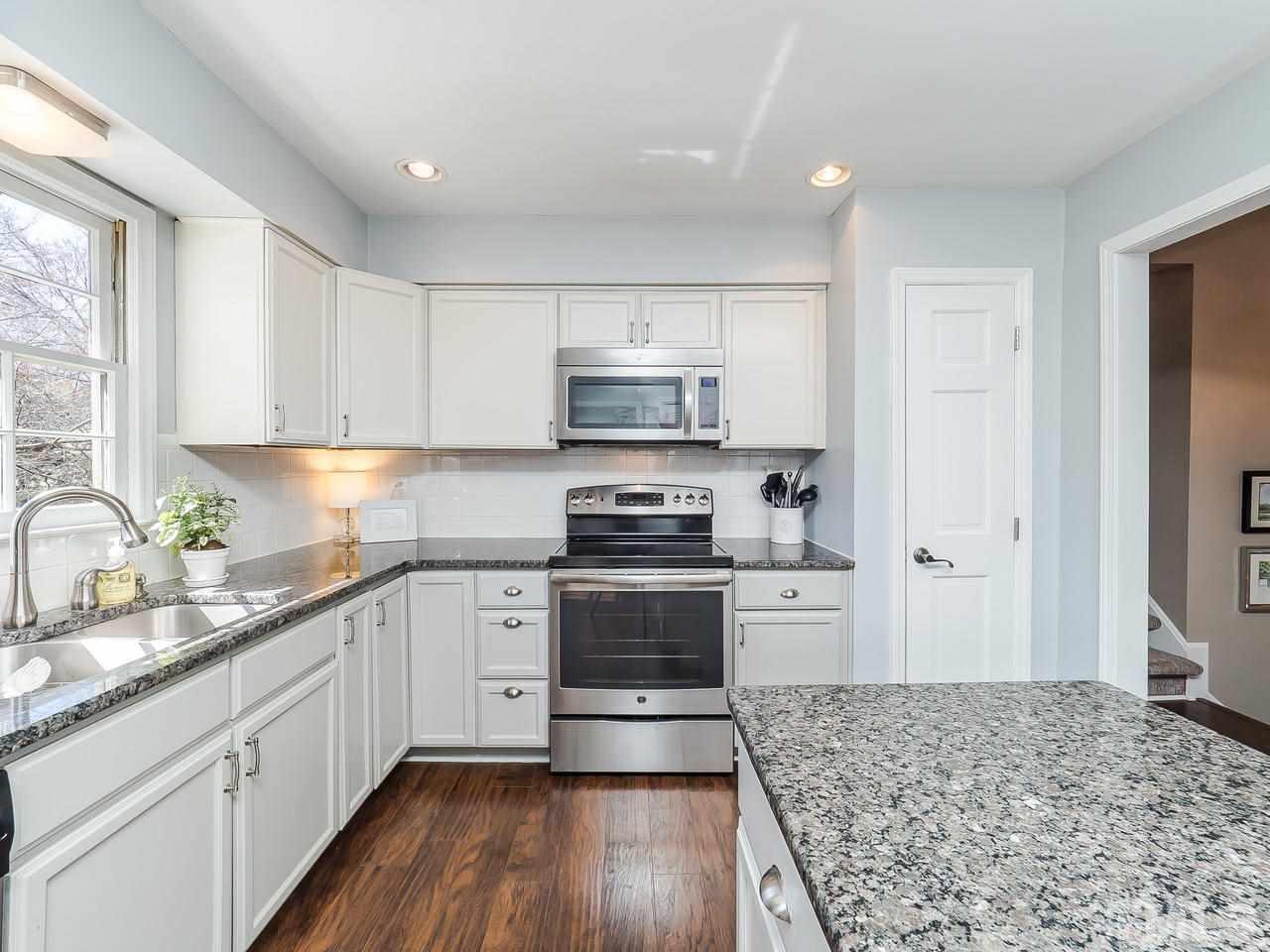 2002 Port Royal Road Raleigh, NC 27609 - Photo 3 of 23 a kitchen with granite countertop a stove and a sink