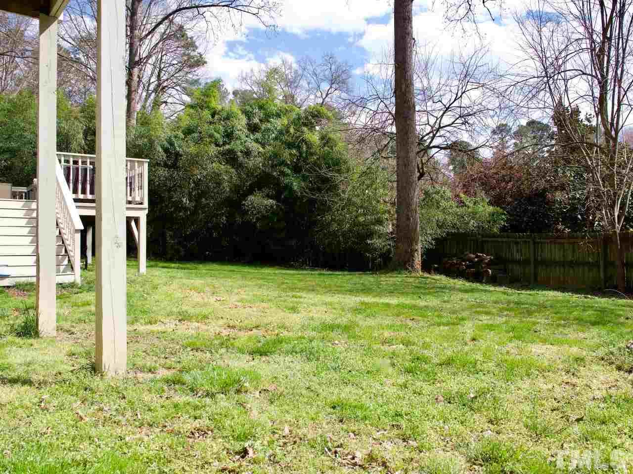 2002 Port Royal Road Raleigh, NC 27609 - Photo 22 of 23 a backyard of a house with lots of green space