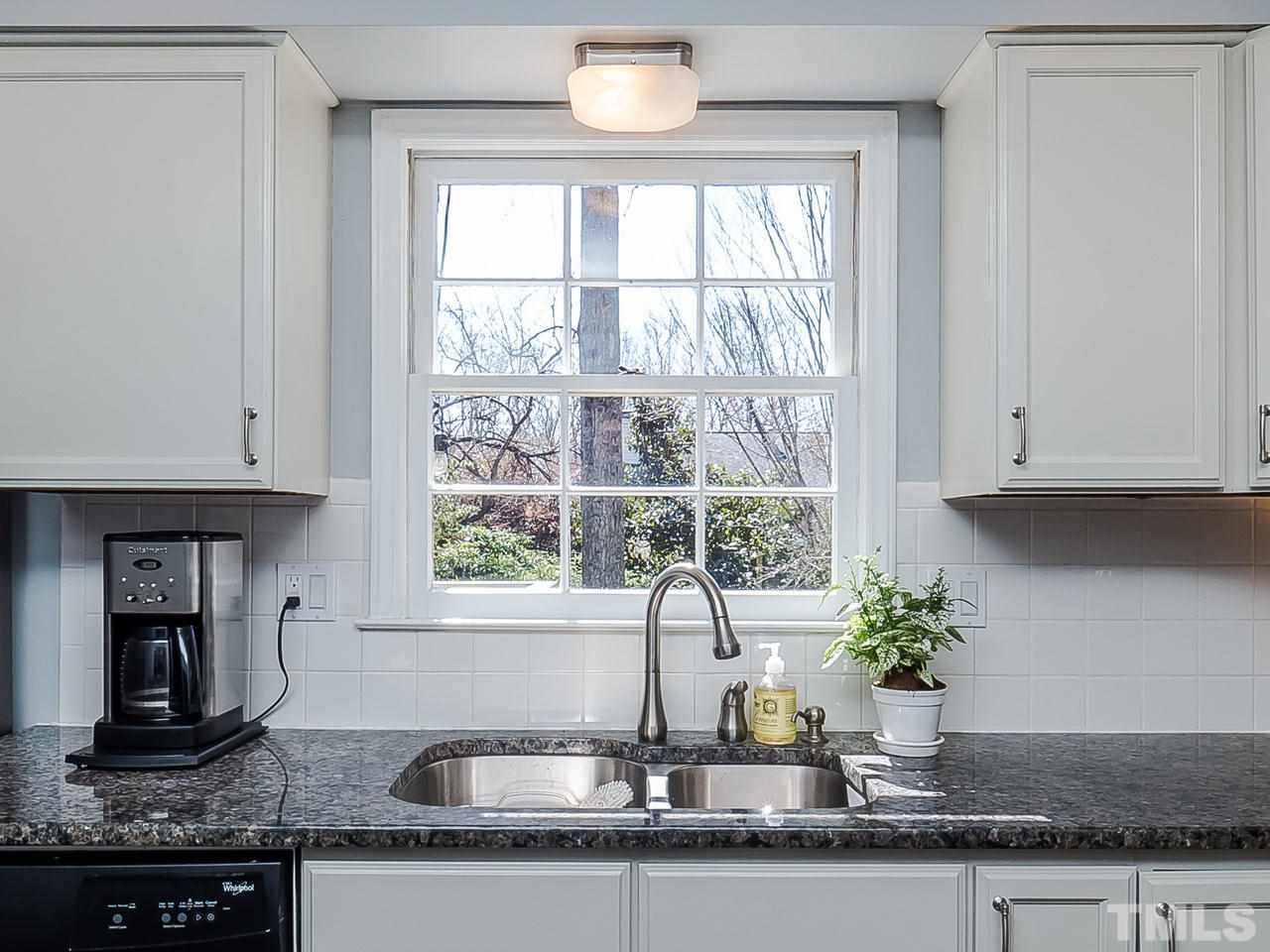 2002 Port Royal Road Raleigh, NC 27609 - Photo 4 of 23 a kitchen with granite countertop a sink and a window