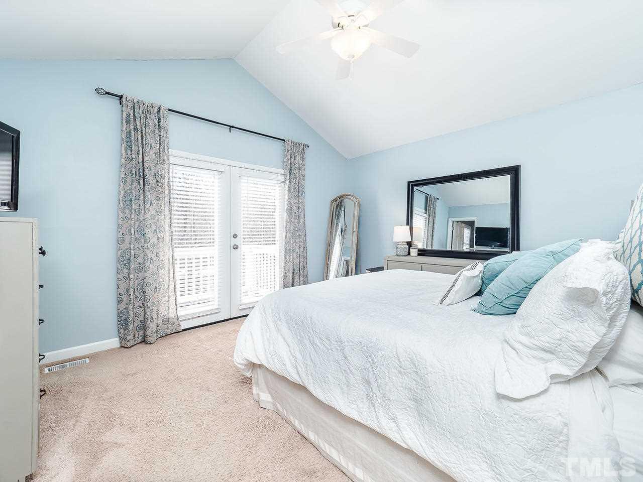 2002 Port Royal Road Raleigh, NC 27609 - Photo 9 of 23 a bedroom with a large bed and a large window